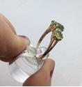 Picture of 14kt yellow gold ring with 4 small diamonds and 3 oval peridots 3.4 gr size 10 .843653-1. 