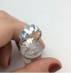 Picture of 14kt white gold ring size 7.25 with 4 small diamonds and 3 light blue oval stones 2.7 gr 803093-1 