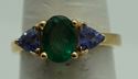 Picture of 14kt yellow gold ring with emerald and tanzanites . Size 6.5 . Total weight 3.3gr. very good condition. Pre owned. Oval emerald and 2 tanzanites . 845374-2. 