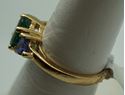 Picture of 14kt yellow gold ring with emerald and tanzanites . Size 6.5 . Total weight 3.3gr. very good condition. Pre owned. Oval emerald and 2 tanzanites . 845374-2. 