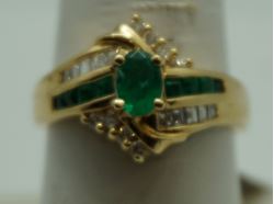 Picture of 14kt yellow gold ring with emeralds and diamonds size 8 5.2 gr total weight .approximately 0.25 carat of diamonds ( 8 round diamonds 10 baguette diamonds) and emeralds 8 e,early cut diamonds 1 oval . 845074-2.