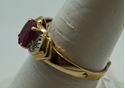 Picture of 10kt yellow gold ring with red stone size 7.25 total weight 2.0 gr . Pre owned.  840097-1.