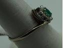 Picture of 14kt white gold ring size 7.5 2.8gr with 10 round diamonds 0.25pts  and marquise emerald 0.10pts. pre owned. very good condition.