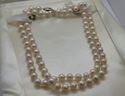 Picture of 26 INCH LONG  PEARL PEACH COLOR (7MM)  NECKLACE WITH 14KT WHITE GOLD CLASP VERY GOOD CONDITION. WITH CASE.