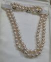 Picture of 26 INCH LONG  PEARL PEACH COLOR (7MM)  NECKLACE WITH 14KT WHITE GOLD CLASP VERY GOOD CONDITION. WITH CASE.