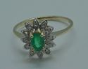 Picture of 14KT YELLOW GOLD FASHION RING SIZE 6.5 2.8 GRAMS WITH EMERALD OVAL STONE AND 12 ROUND DIAMONDS.  PRE OWNED. VERY GOOD CONDITION. 851806-1.