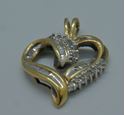 Picture of 10kt yellow gold 2.6 grams diamond heart pendant 14 round .16 baguette diamonds 0.25 ctw 806514-1