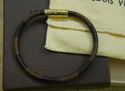 Picture of Louis Vuitton cowhide leather bracelet M6609D pre owned with case and dust bag.  pre owned. very good condition. 